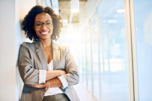 A woman, smiling, because she knows she’s found the best debt consolidation company