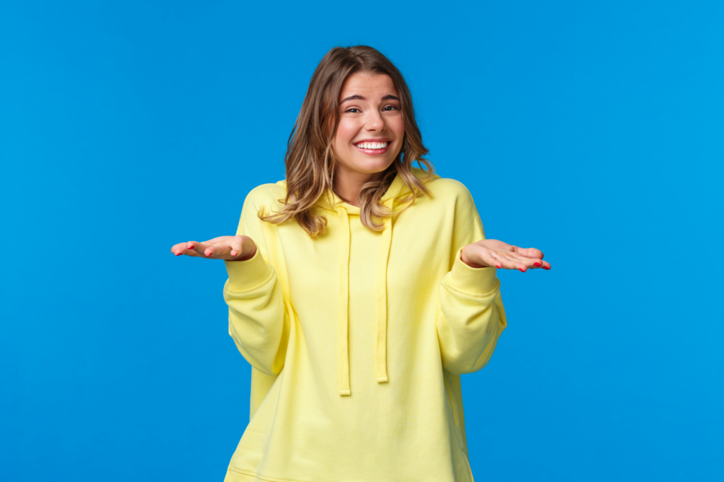 Young Woman in yellow sweater shrugging